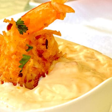 Coconut Shrimp sitting in dipping sauce