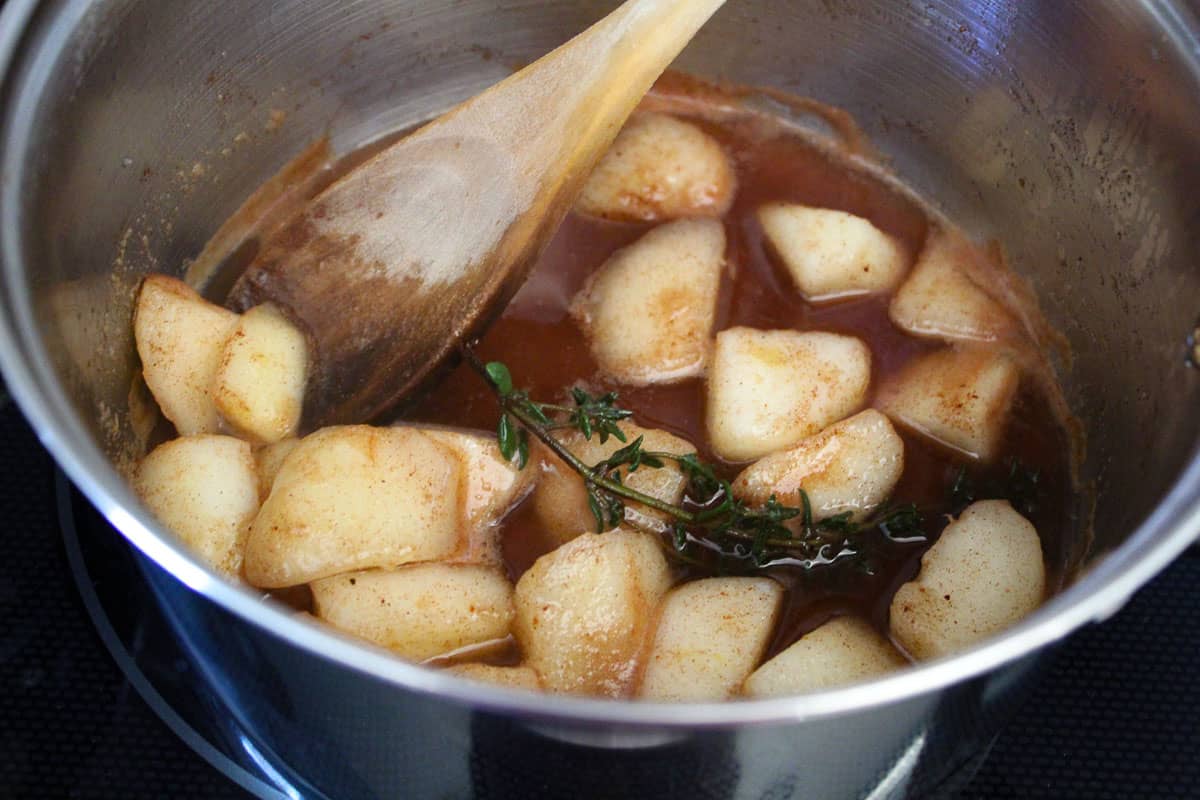 Chopped pears in braising liquid in saucepan