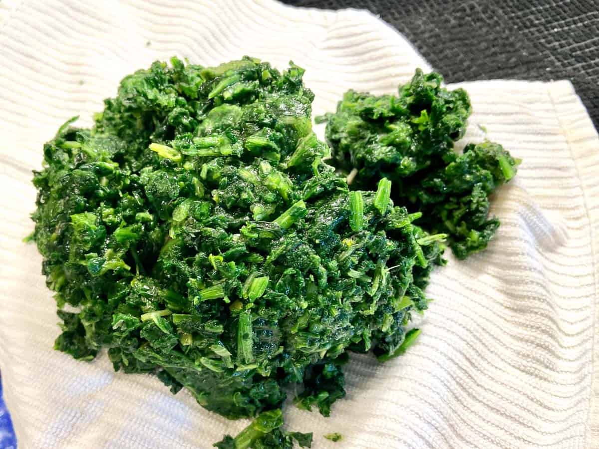 Frozen spinach on white dish towel.