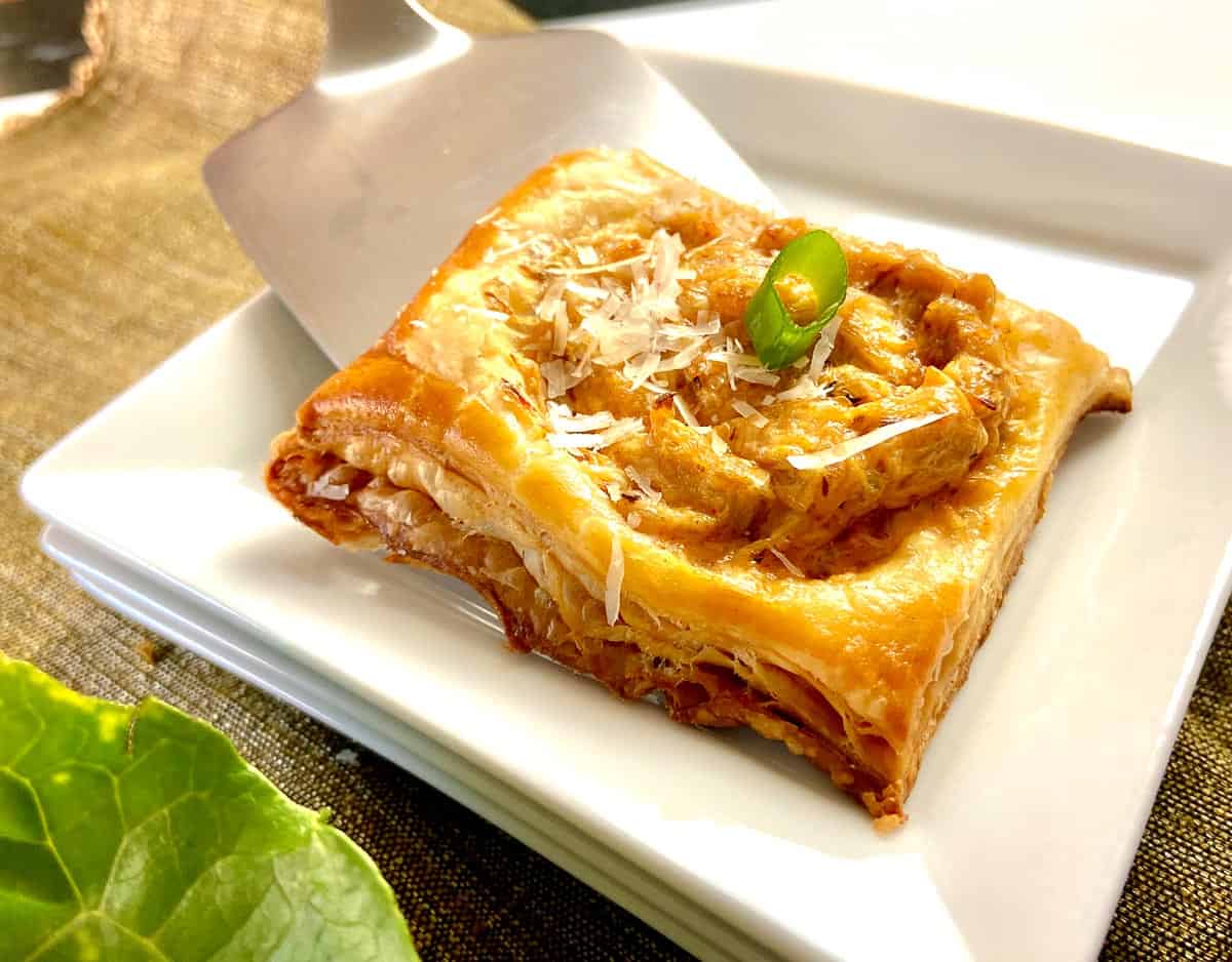 Crab Puff being served onto small white plate.