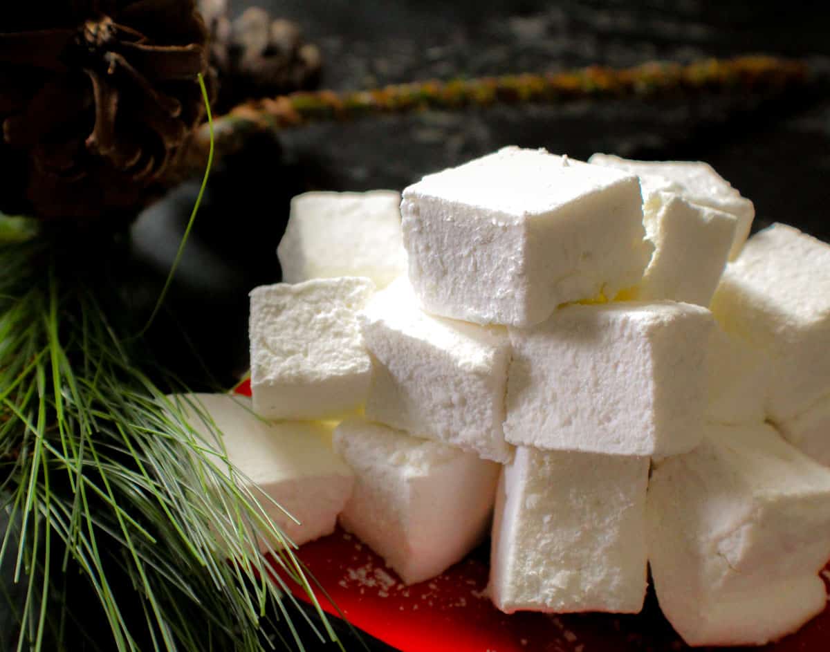 Marshmallow squares stacked on a red plate