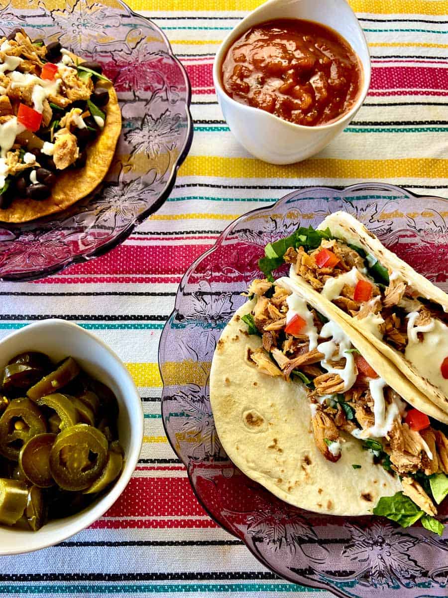 Dutch oven chicken carnitas on decorative plate.