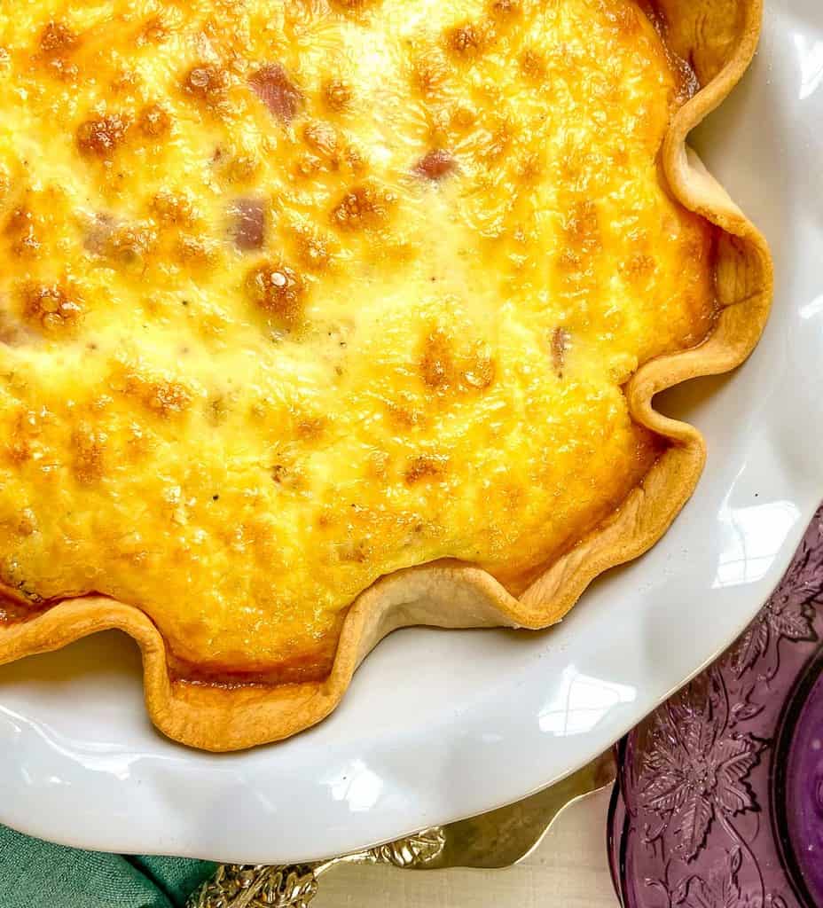 Quiche in a white scalloped pie plate