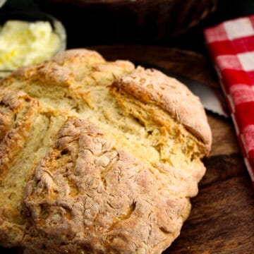 Rustic loaf of Irish soda bread on cutting board