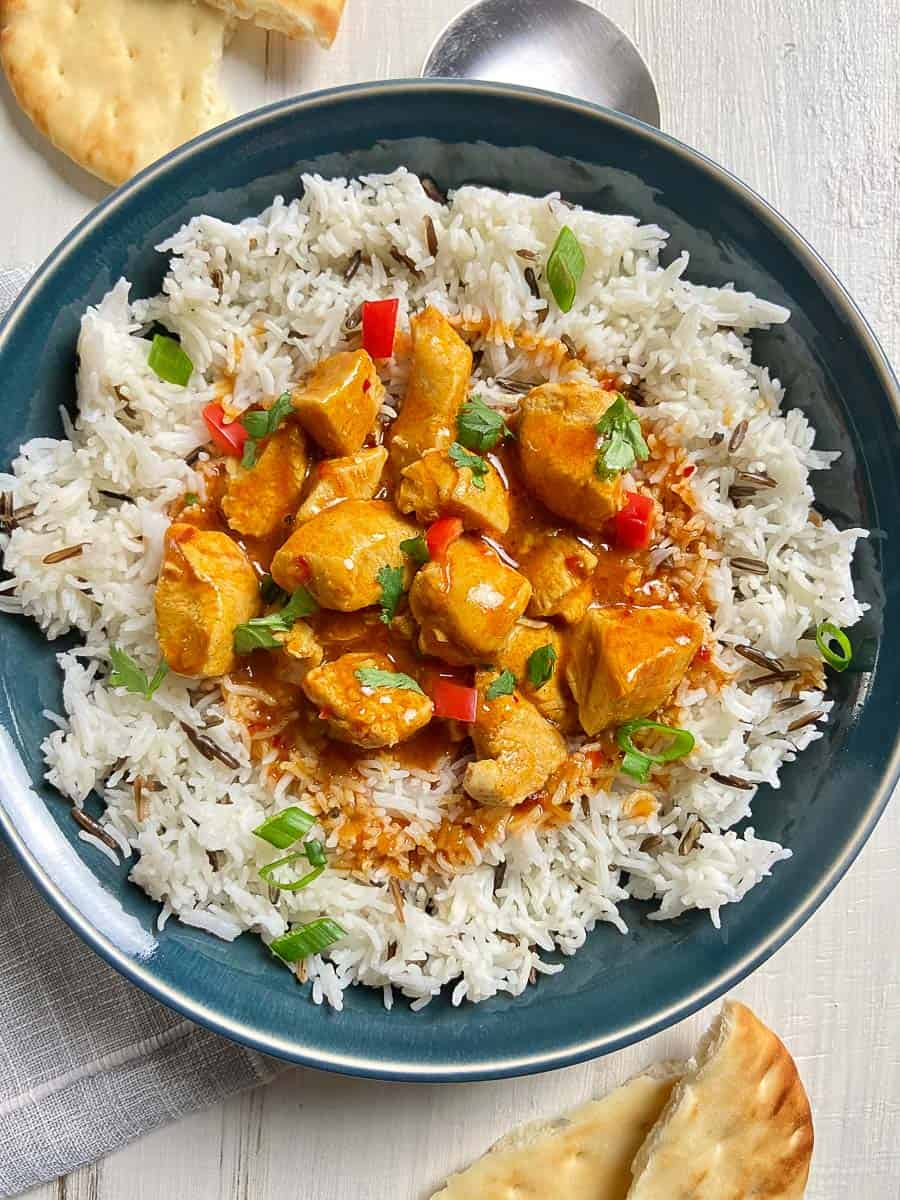 Butter Chicken with basmati rice in blue bowl