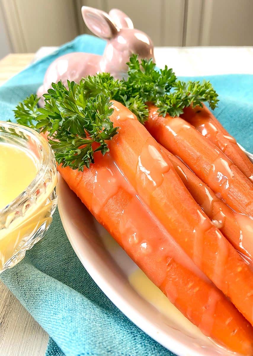 Orange glazed carrots in white bowl