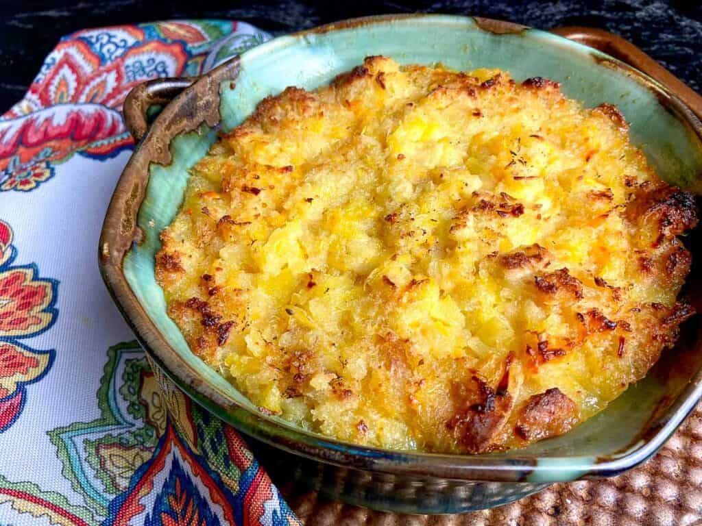 Pineapple casserole in turquoise baking dish.