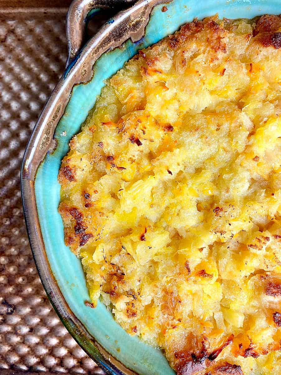 Pineapple casserole in turquoise baking dish.