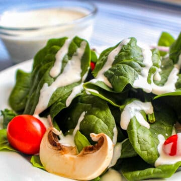 Buttermilk Dill Ranch Dressing on spinach greens with cherry tomatoes and mushroom slices