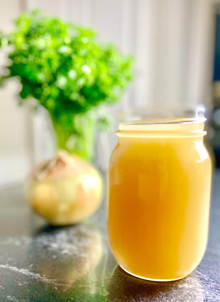 Homemade Chicken Broth in mason Jar on the counter.