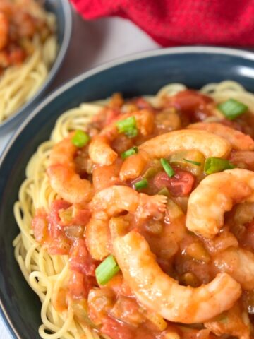 Creole shrimp pasta in blue bowl.