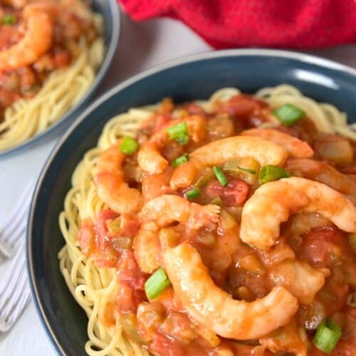 Creole shrimp pasta in blue bowl.