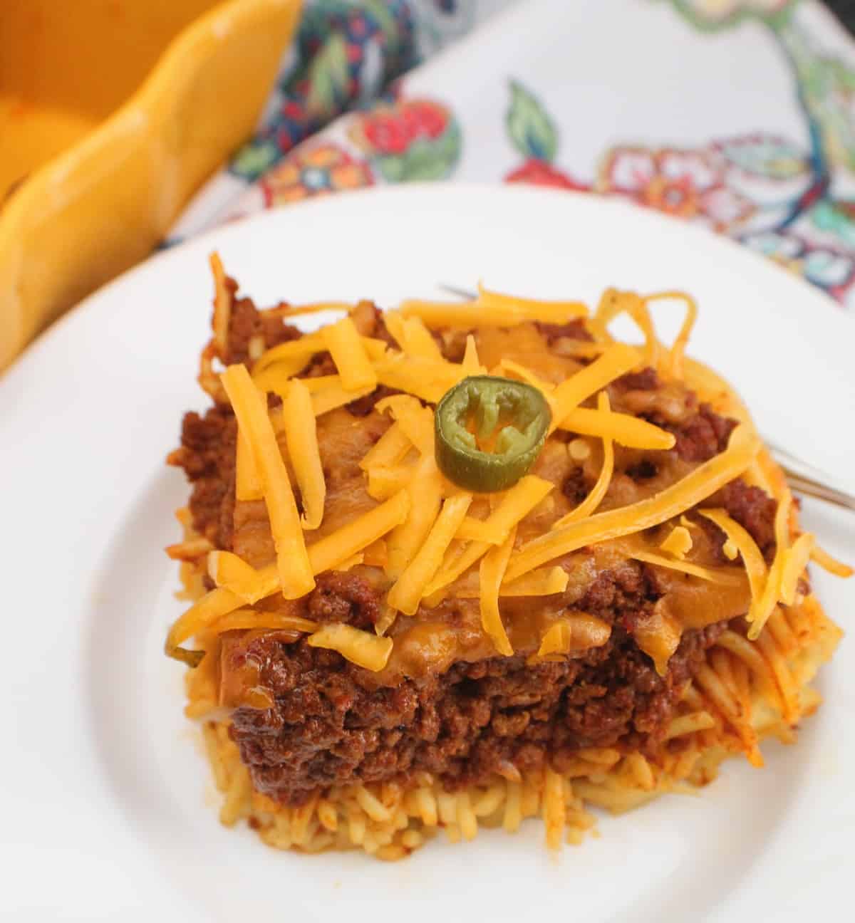 Chili spaghetti pie on white plate.