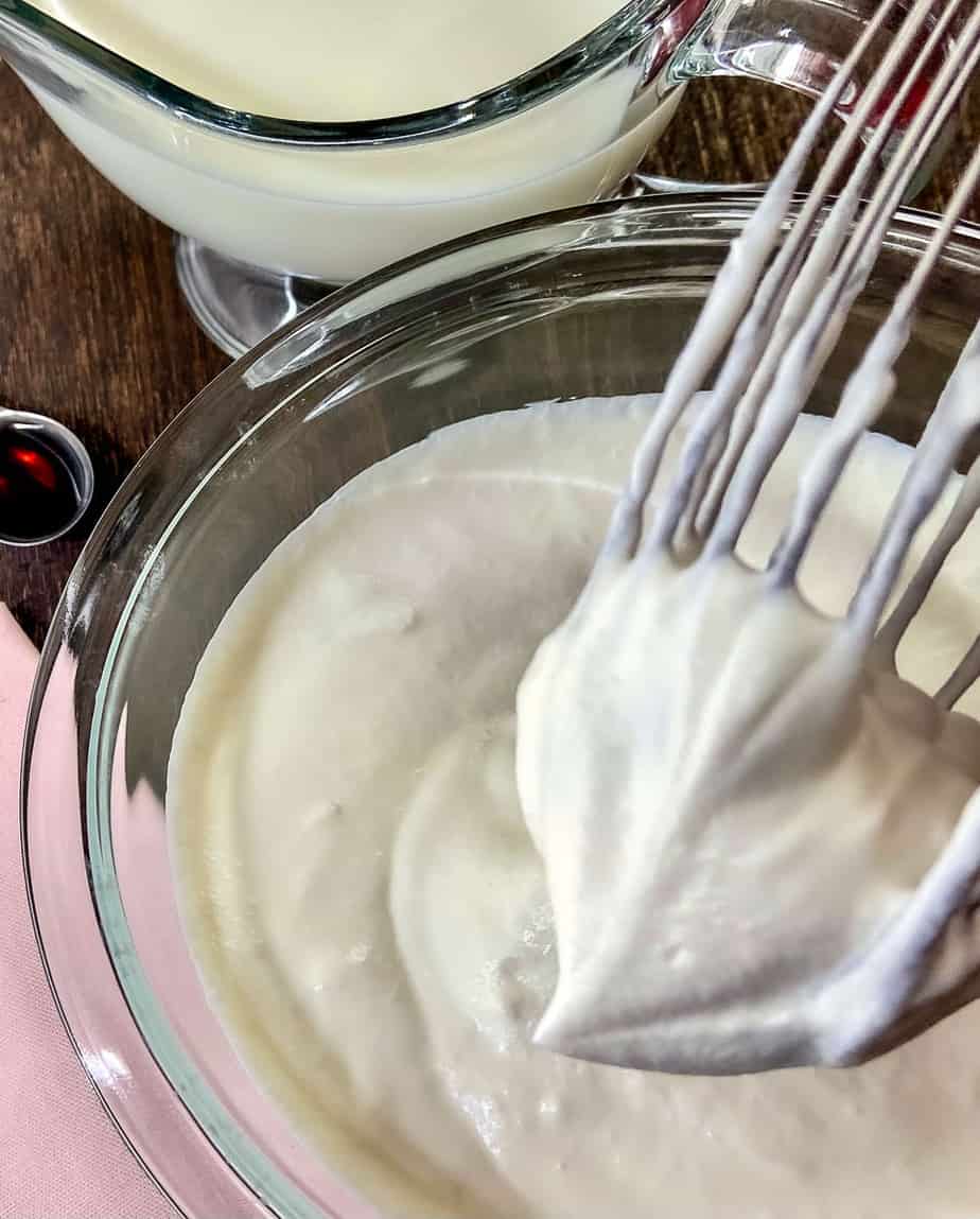 Homemade whipped cream on wire whisk