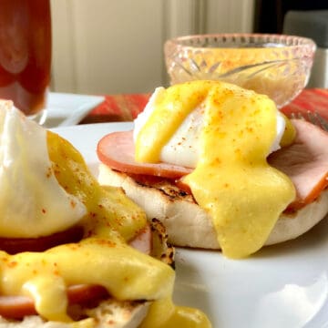 Hollandaise sauce on eggs benedict.