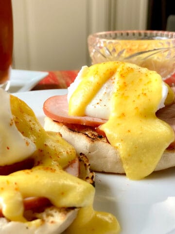 Hollandaise sauce on eggs benedict.