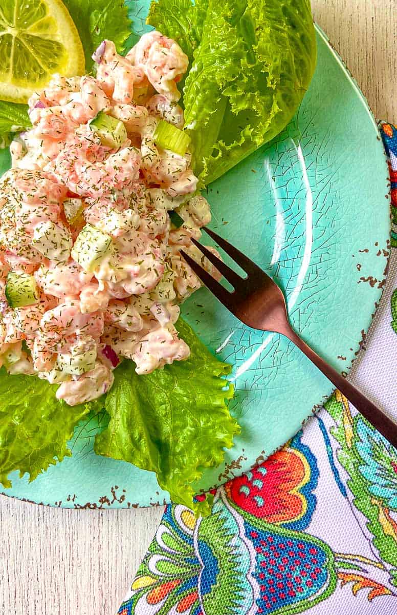 Cold Dill Shrimp Salad on lettuce greens on turquoise plate