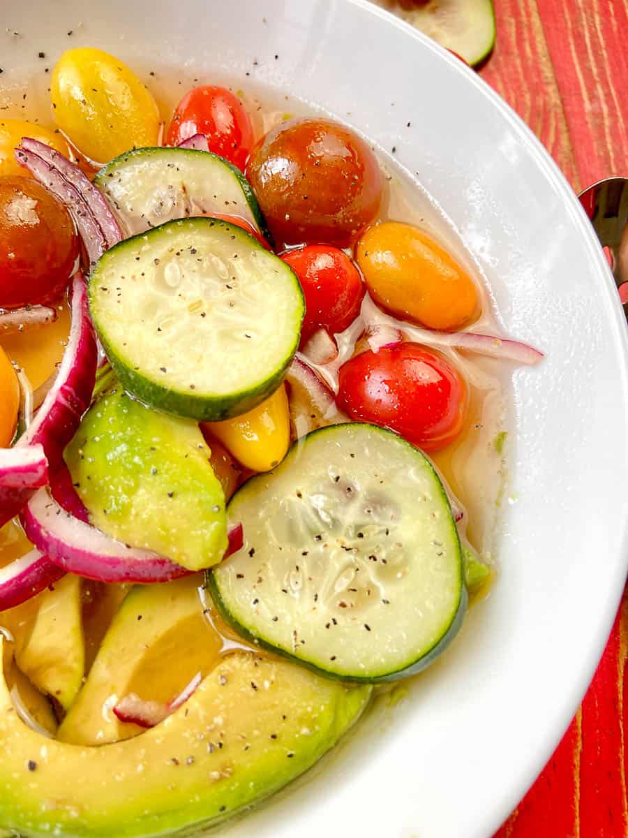 Close up of marinated salad in white bowl.