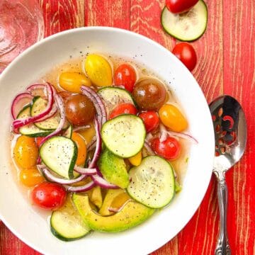 White bowl of marinated vegetable salad.