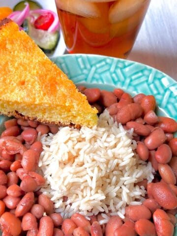 Pinto beans and rice with a slice of cornbread on the side.