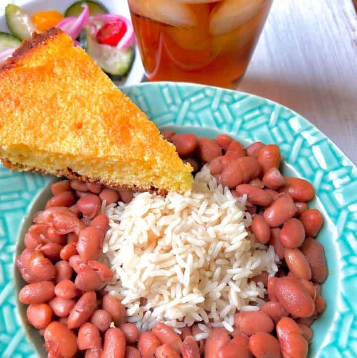 Pinto beans and rice with a slice of cornbread on the side.