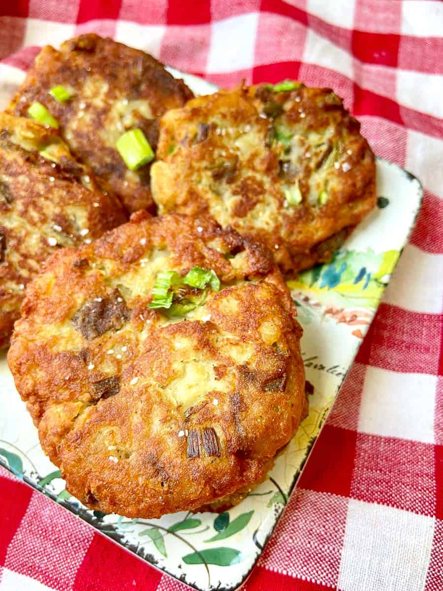 Fried potato cakes on decorative plate.