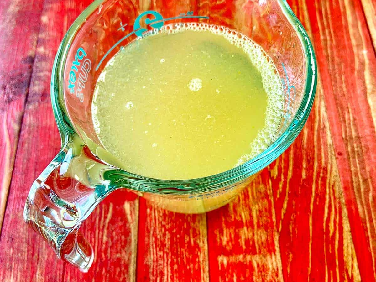 Lemonade concentrate in two-cup measuring cup.