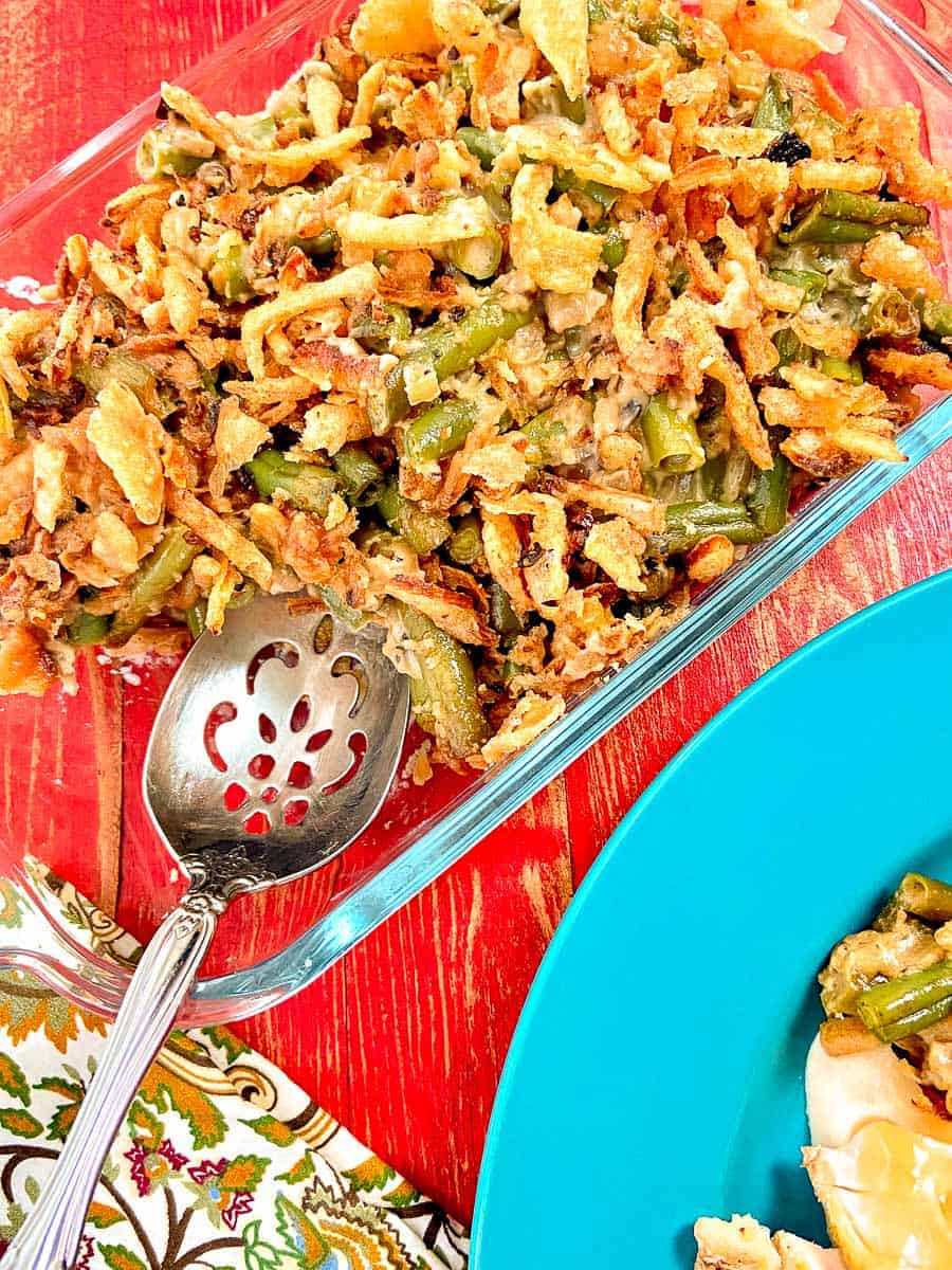 Green Bean Casserole in baking dish with serving spoon.