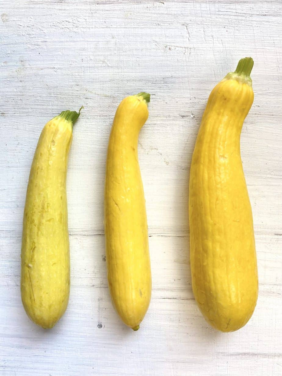 Three sizes of squash on a table.