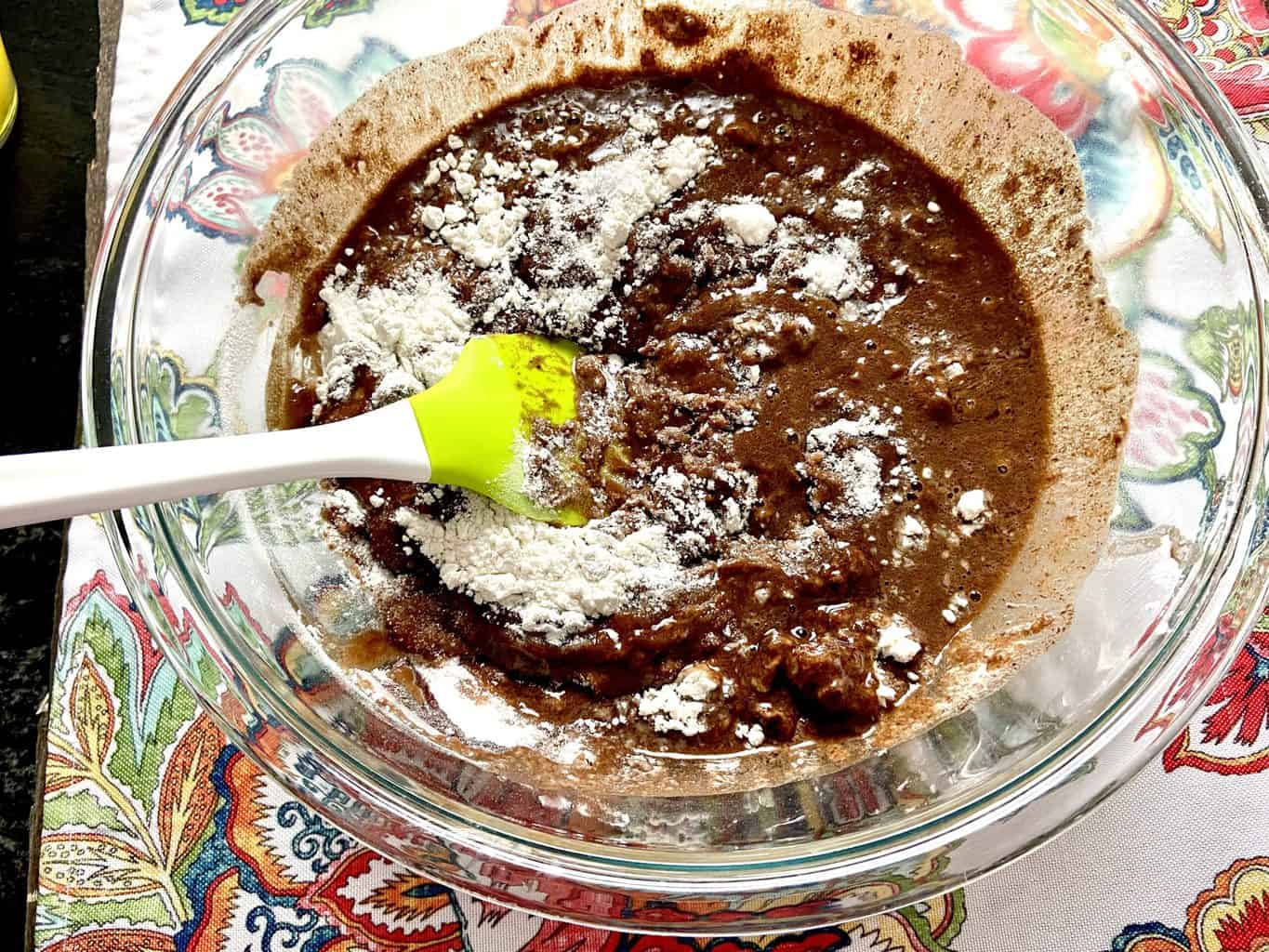 Chocolate cake batter, sugar and flour in mixing bowl.