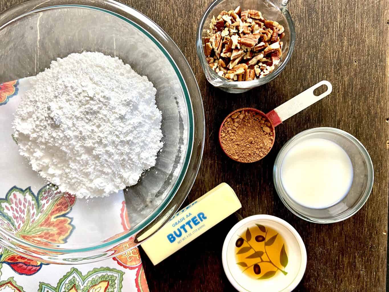 Chocolate pecan icing ingredients on counter.