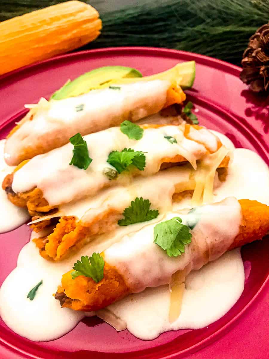 Sour Cream Sauce drizzled over tamales.