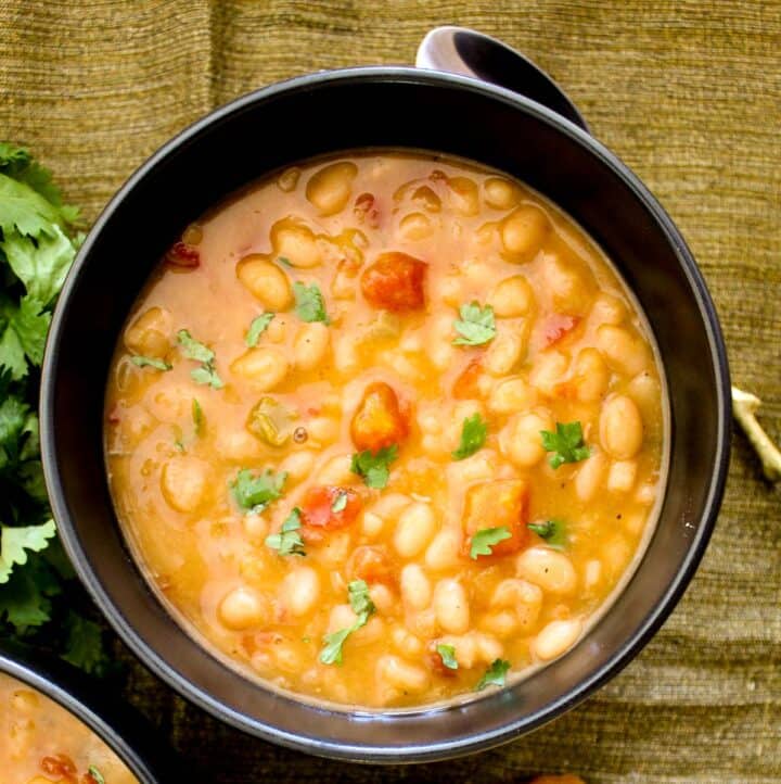 Navy bean soup in black bowl.