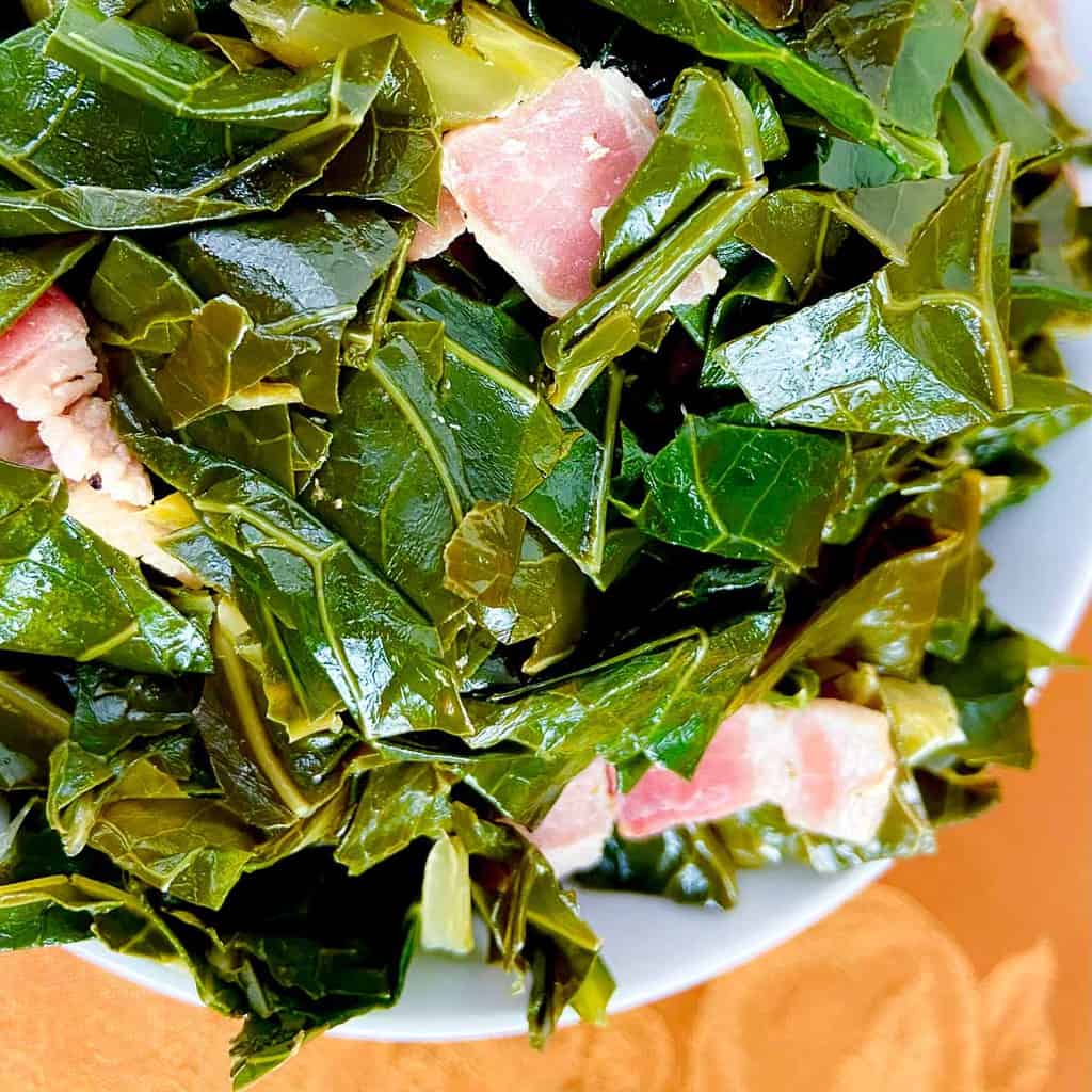 Seasoned greens in a white bowl.