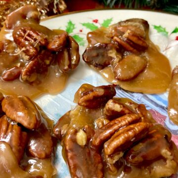 Clusters of pecan pralines onn decorative plate.