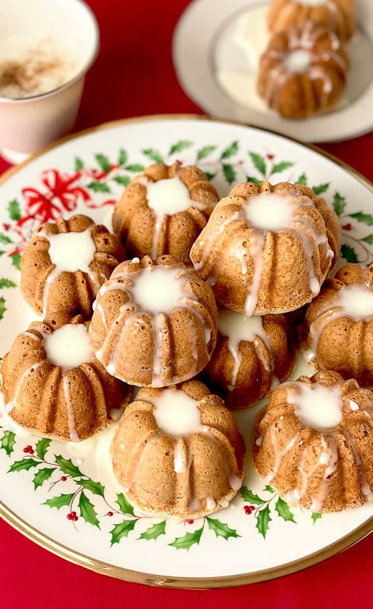 Mini eggnog cakes stacked on a decorative platter.