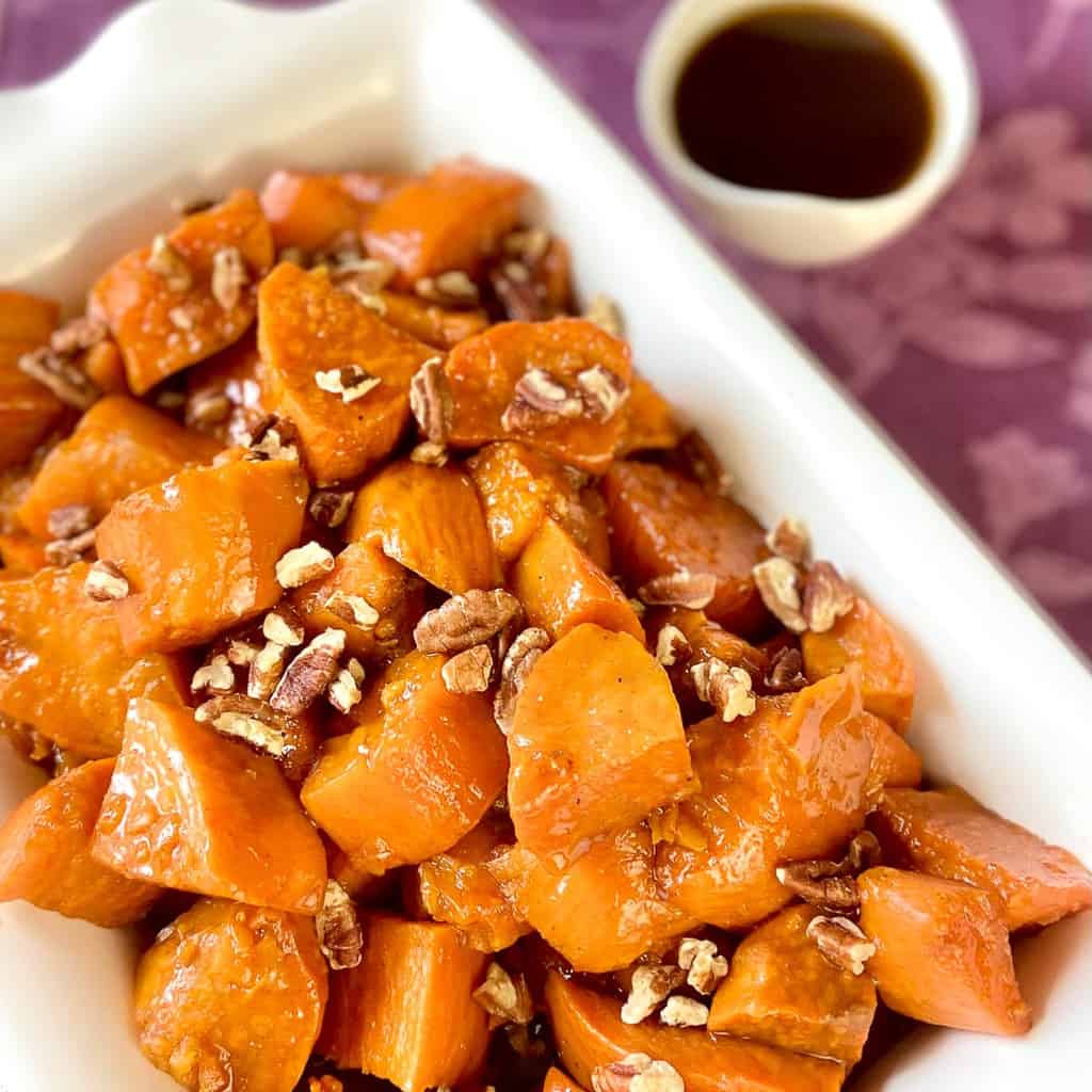 Candied sweet potatoes in a rectangular serving platter.