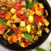 Ratatouille in black bowl closeup.