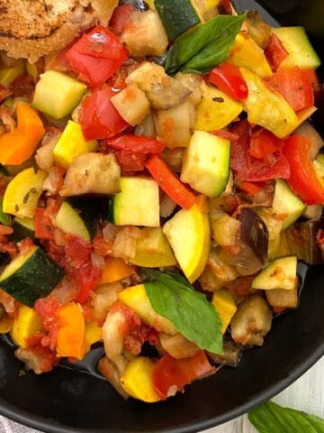 Ratatouille in black bowl closeup.