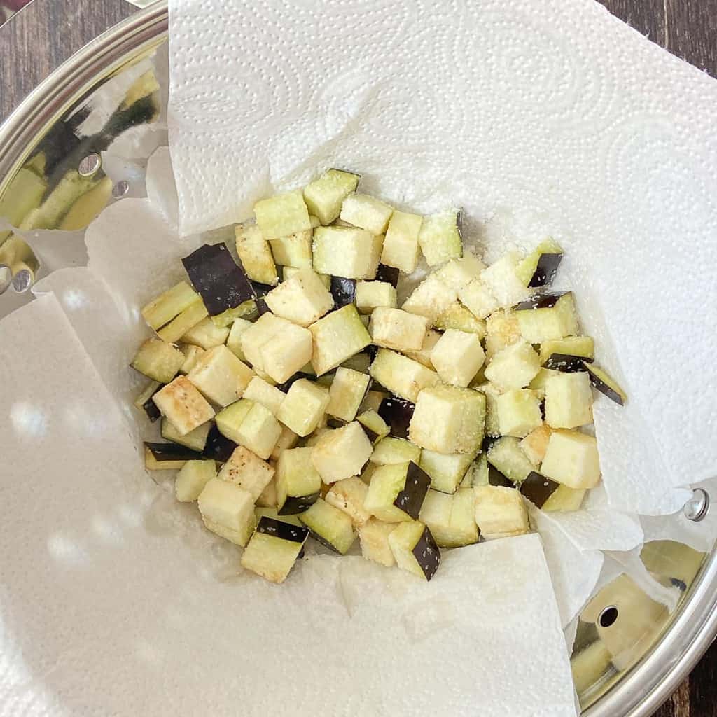 Diced eggplant in colander.