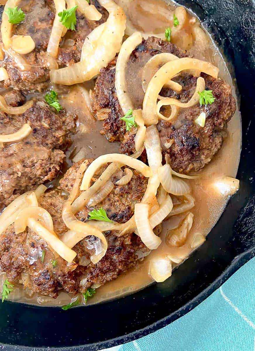 Salisbury steak in cast iron skillet.