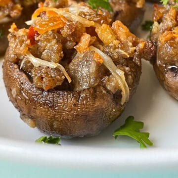 Sausage Stuffed Mushrooms on white plate.