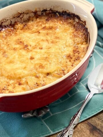 Scalloped potatoes in oval baking dish.