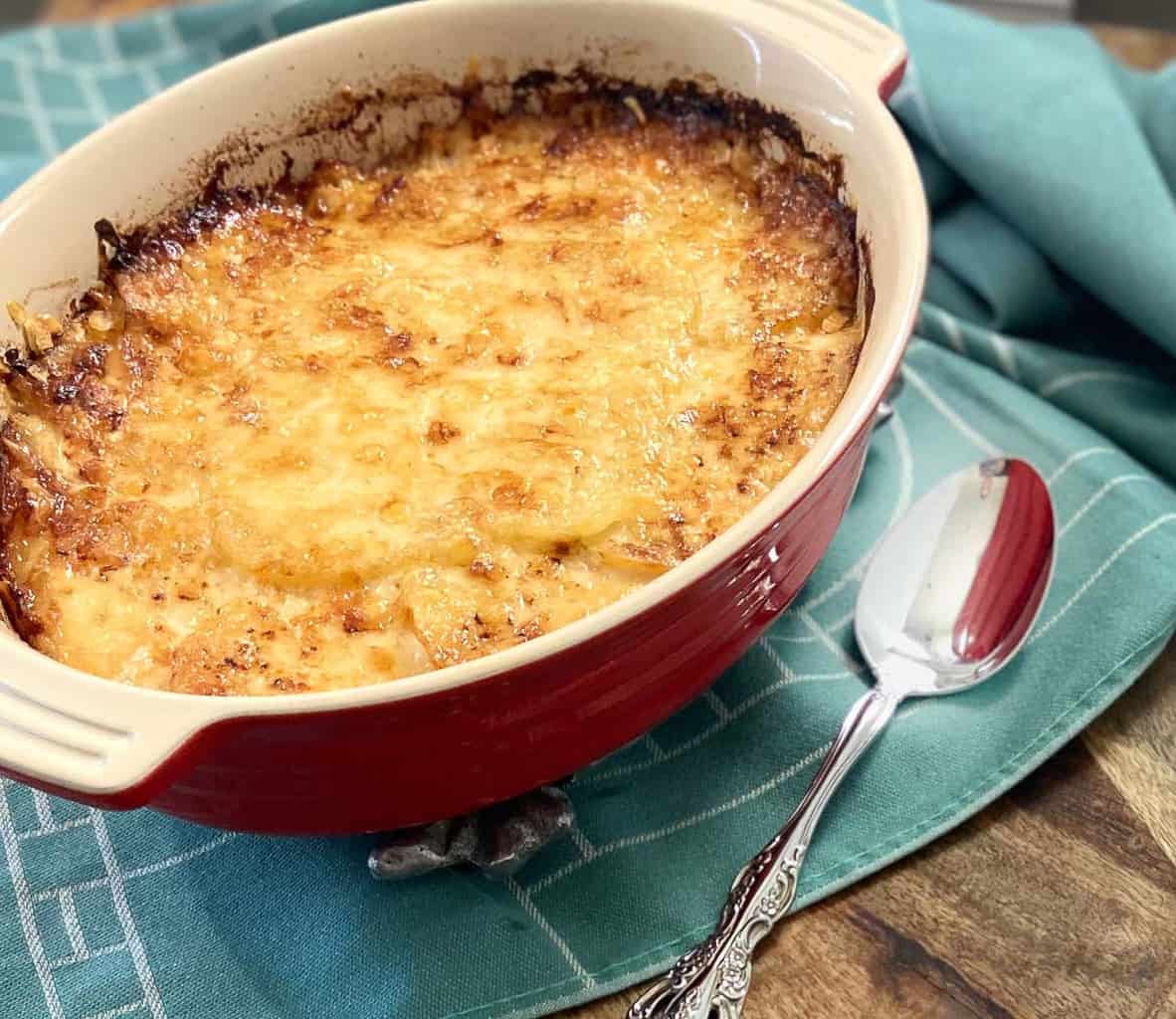 Scalloped potatoes in oval baking dish.