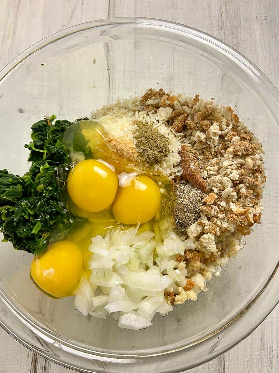 Spinach ball ingredients in mixing bowl.