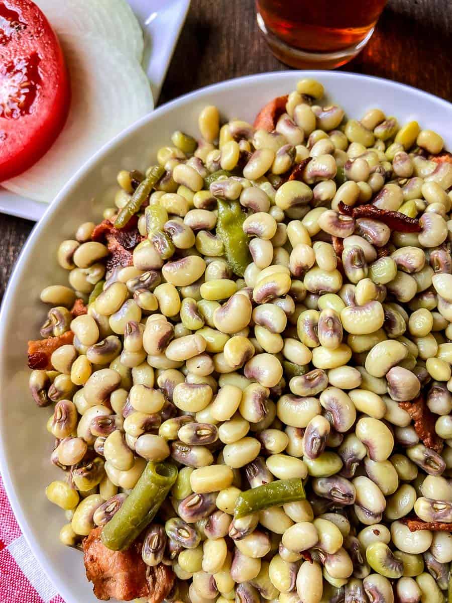 Purple hull peas in white bowl.