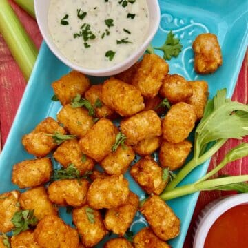 Buffalo tater tots on turquoise platter.