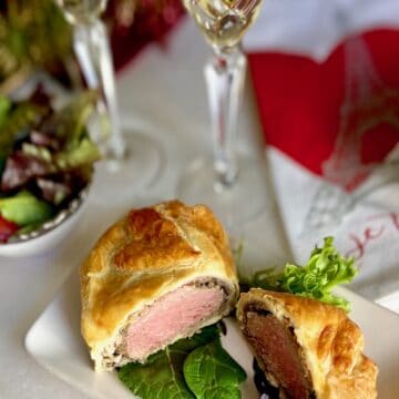 Sliced Beef Wellington on white plate.