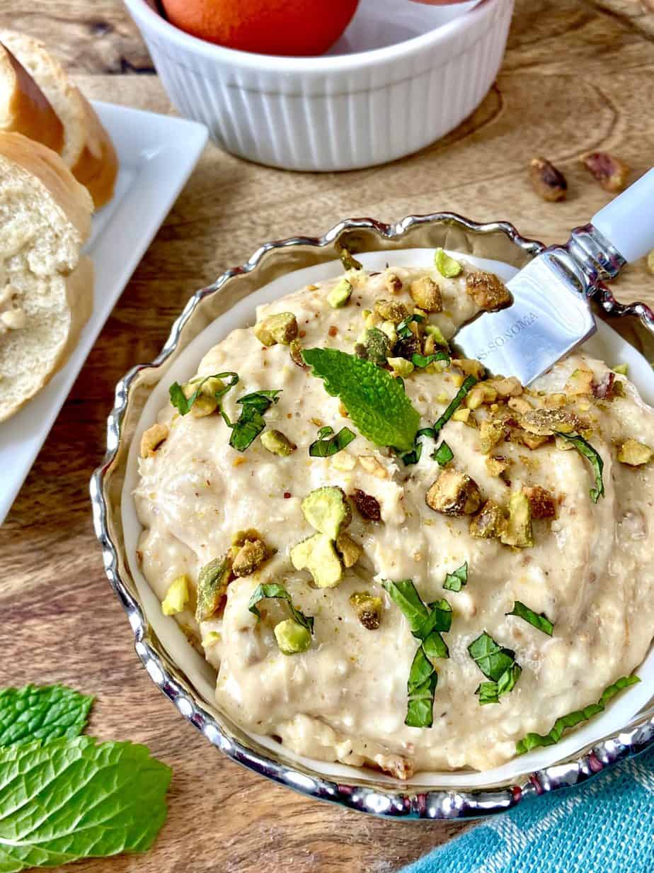 Orange fig spread garnished with mint and chopped pistachios.