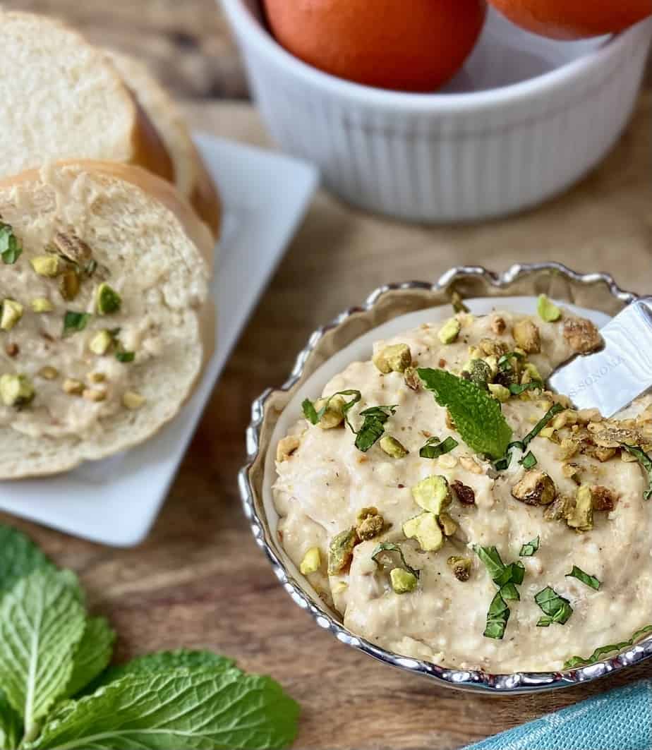Orange fig spread garnished with pistachios and mint.